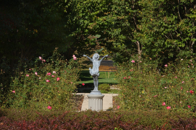 Statue of a Happy Girl Raising Her Arms in the Waverly Gardens